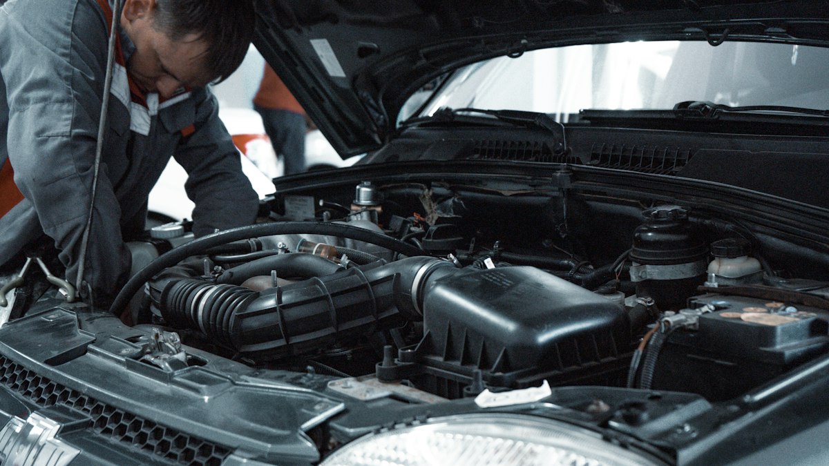 Mobile mechanic inspecting a car's engine bay